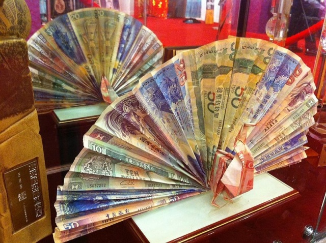 A paper fan made of money